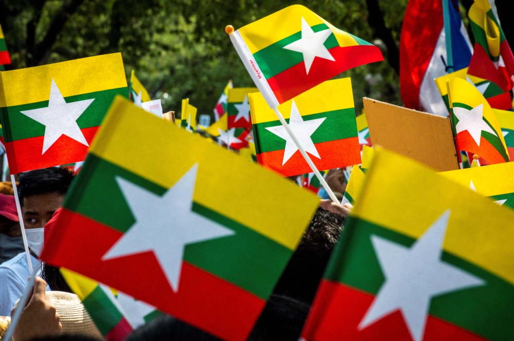 Myanmar migrants in Thailand protest against the military coup in their home country, in front of the United Nations ESCAP building in Bangkok on February 22, 2021. — AFP pic