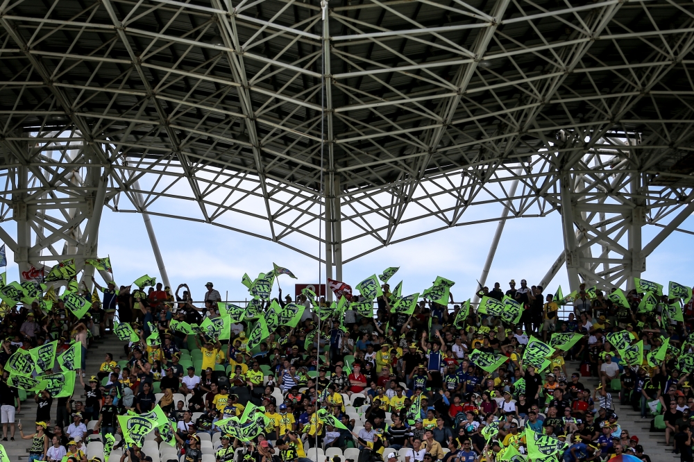 Fans of the Movistar Yamaha MotoGP Valentino Rossi wave the VR46 flag during the second qualifying session at MotoGP 2018 Shell Malaysia in this file picture taken on November 3, 2018. — Picture by Hari Anggara