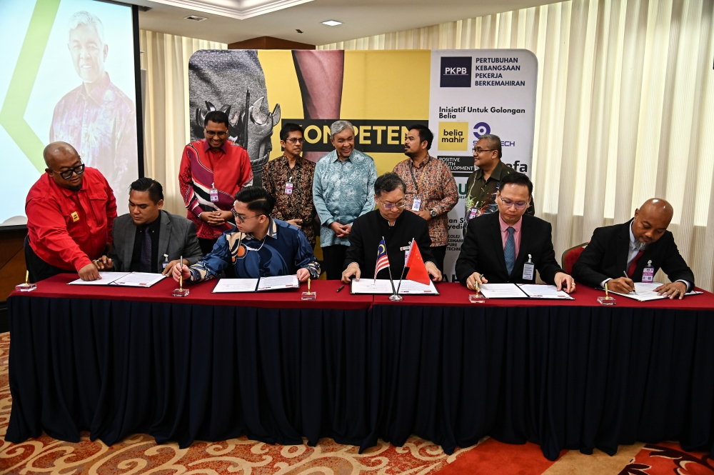 Deputy Prime Minister Datuk Seri Ahmad Zahid Hamidi (standing, centre) witnesses the signing ceremony of the Memorandum of Understanding (MoU) on the Malaysia-China Youth TVET Training Programme in Kuala Lumpur November 9, 2023. — Bernama pic