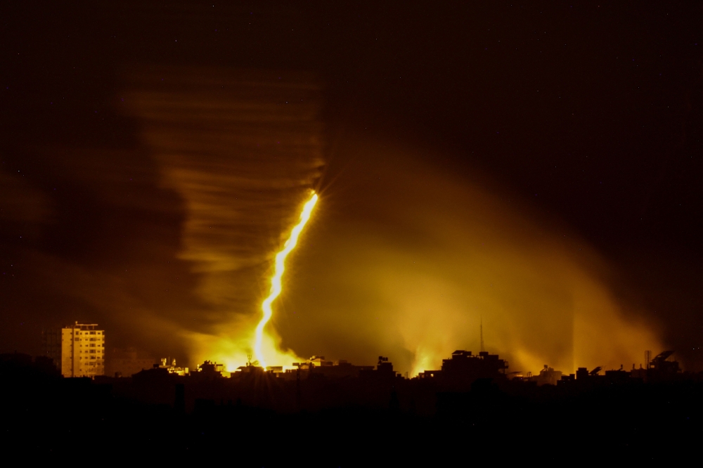 This picture taken from the Israeli side of the border with the Gaza Strip, shows flares being fired by Israeli troops over the Gaza Strip during Israeli bombardment amid ongoing battles with the Palestinian Hamas movement. — AFP pic