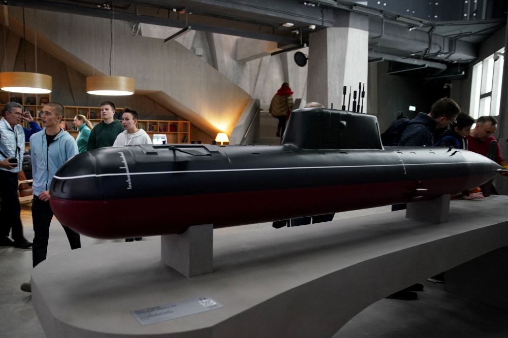 People walk past a model of a Soviet K-278 nuclear submarine as they visit Russia Expo, an exhibition designed to demonstrate Russia's main achievements in culture and technology, at the All-Russia Exhibition Centre (VDNH) in Moscow on November 4, 2023. Under Russia's suspended agreement with Japan, Tokyo helped decommission weapons, including dismantling nuclear submarines. — AFP pic