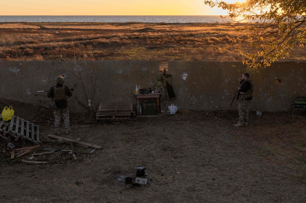 Ukrainian servicemen of the 123rd Territorial Defense Brigade stand guard on a position next to the Dnipro River, in an undisclosed location in the Kherson region, on November 6, 2023, amid the Russian invasion of Ukraine. — AFP pic