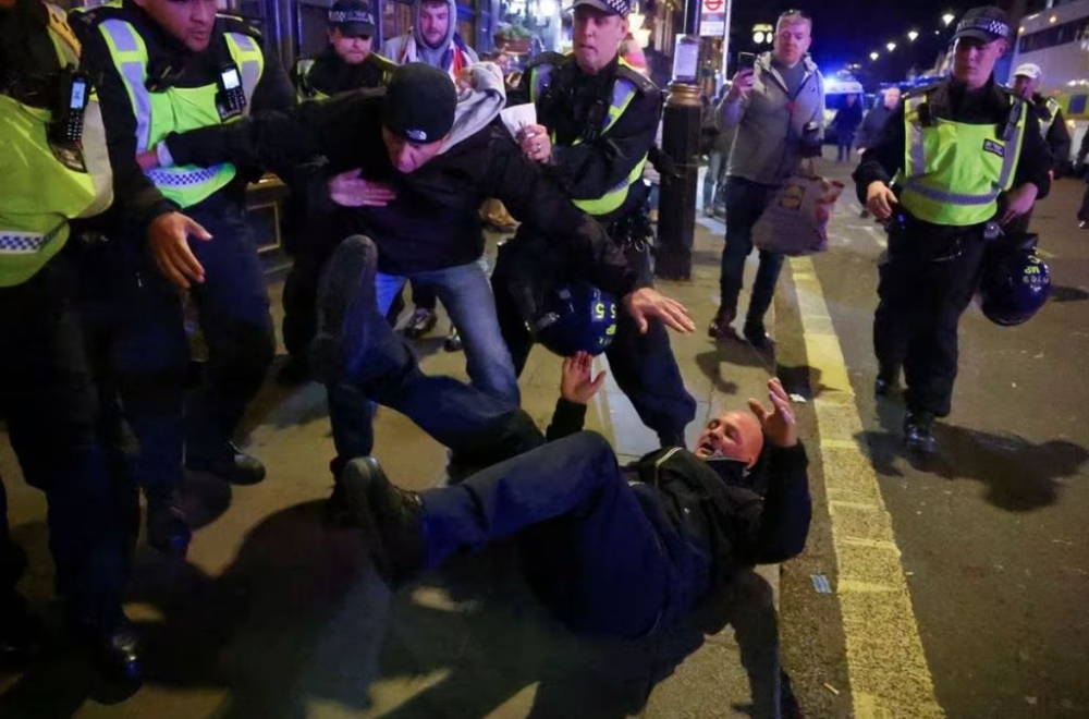 Police officers detain a counter-protester on the day of a demonstration in solidarity with Palestinians in Gaza, amid the ongoing conflict between Israel and the Palestinian Islamist group Hamas, in London, Britain, November 11, 2023. — Reuter pic