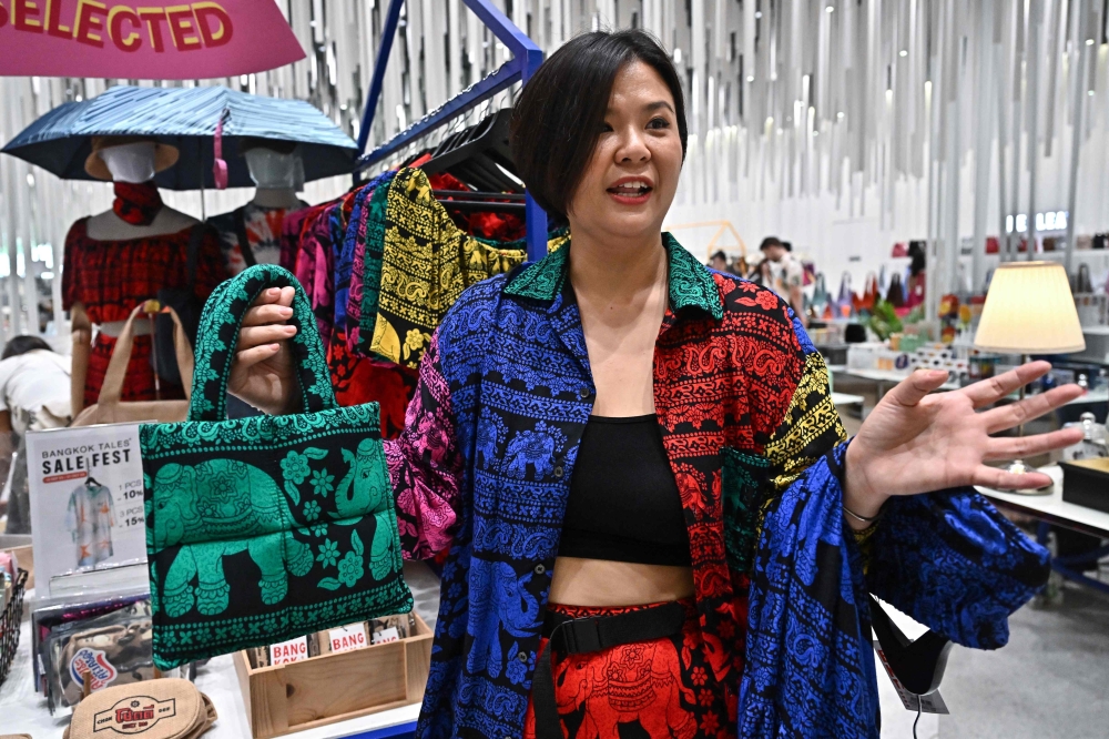 Bangkok Tales clothing brand co-founder and designer Gigi Wo showing her clothing items made with elephant print at Icon Siam shopping mall in Bangkok. — AFP pic