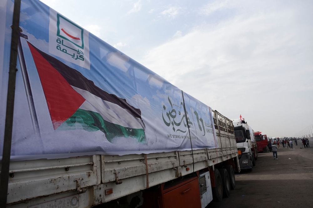 Trucks carrying humanitarian aid to Palestinians, wait on the desert road (Cairo - Ismailia) on their way to the Rafah border crossing to enter Gaza, amid the ongoing conflict between Israel and the Palestinian Islamist group Hamas, in Cairo, Egypt, November 12, 2023. — Reuters pic