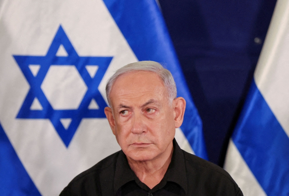 At a news conference, Israeli Prime Minister Benjamin Netanyahu aired his long-standing grievances over the PA’s school syllabus, which he says fuels hatred of Israel, and its policy of giving salaries to families of Palestinians imprisoned in Israel. — Pool via Reuters pic