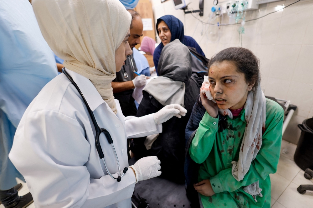 A wounded Palestinian woman following an Israeli strike, receives medical treatment at a hospital, amid the ongoing conflict between Israel and Palestinian group Hamas, in Khan Younis in the southern Gaza Strip November 12, 2023. — Reuters pic