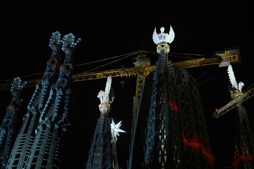 The Sagrada Familia basilica's towers of the Evangelists are lit up for the first time, following a blessing ceremony, marking their completion, on November 12, 2023 in Barcelona. — AFP pic