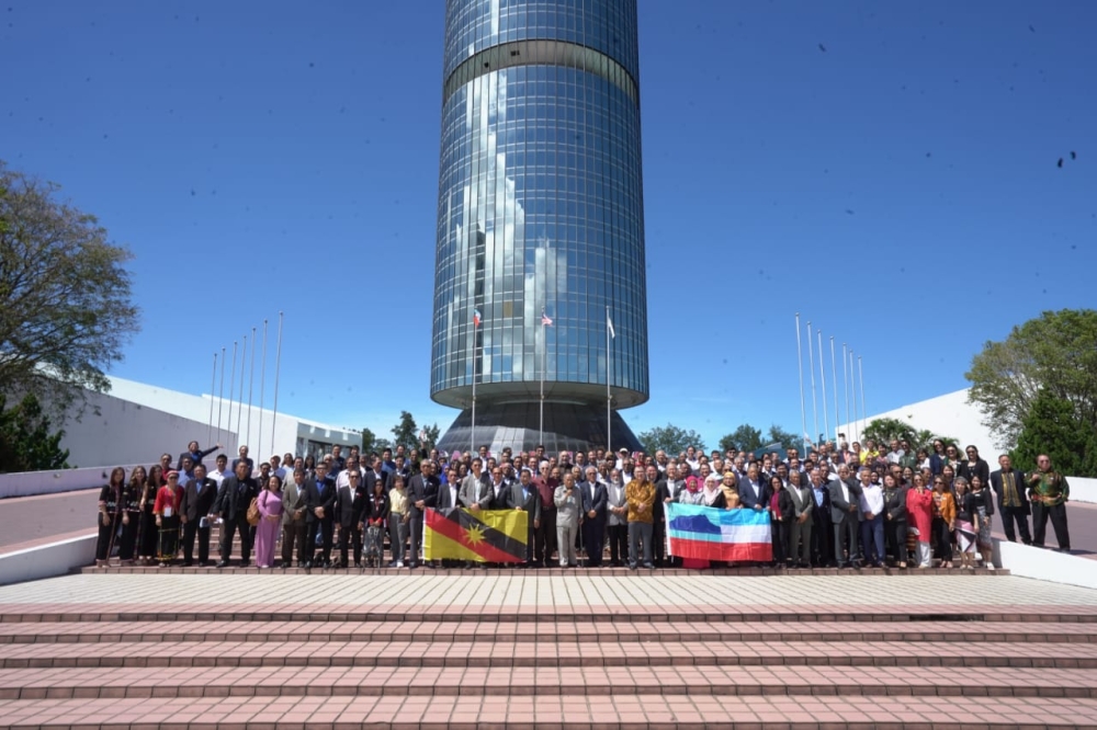 Participants pose in front of the Yayasan Sabah building where the symposium was held. — Borneo Post Online pic