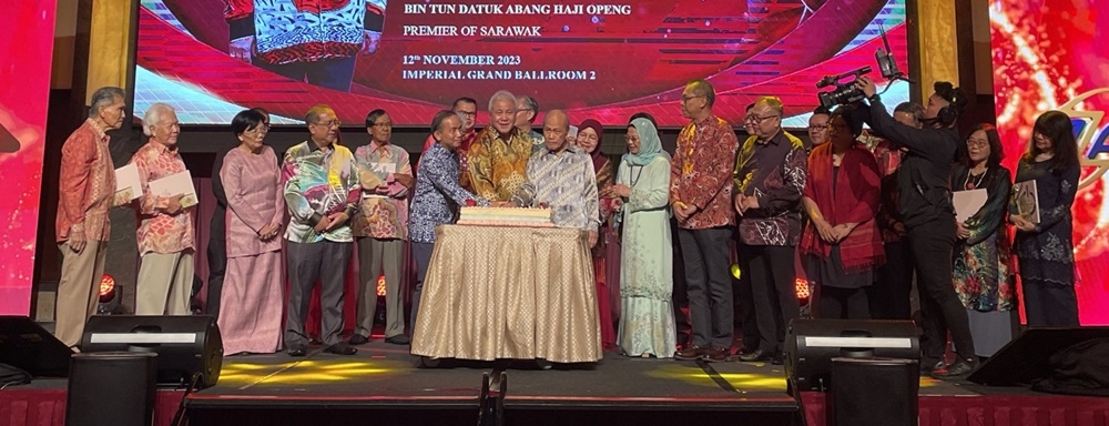 Awang Tengah leads the cake cutting ceremony to commemorate the four-decade journey of Azam Sarawak at the event. — Borneo Post Online pic