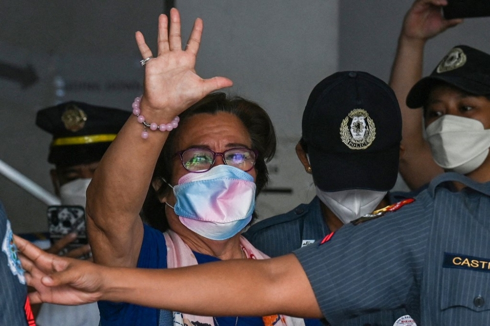 This file photo taken on September 30, 2022 shows former Philippine senator and human rights campaigner Leila de Lima (centre) leaving after attending her hearing at the Muntinlupa Trial Court in Metro Manila. — AFP pic