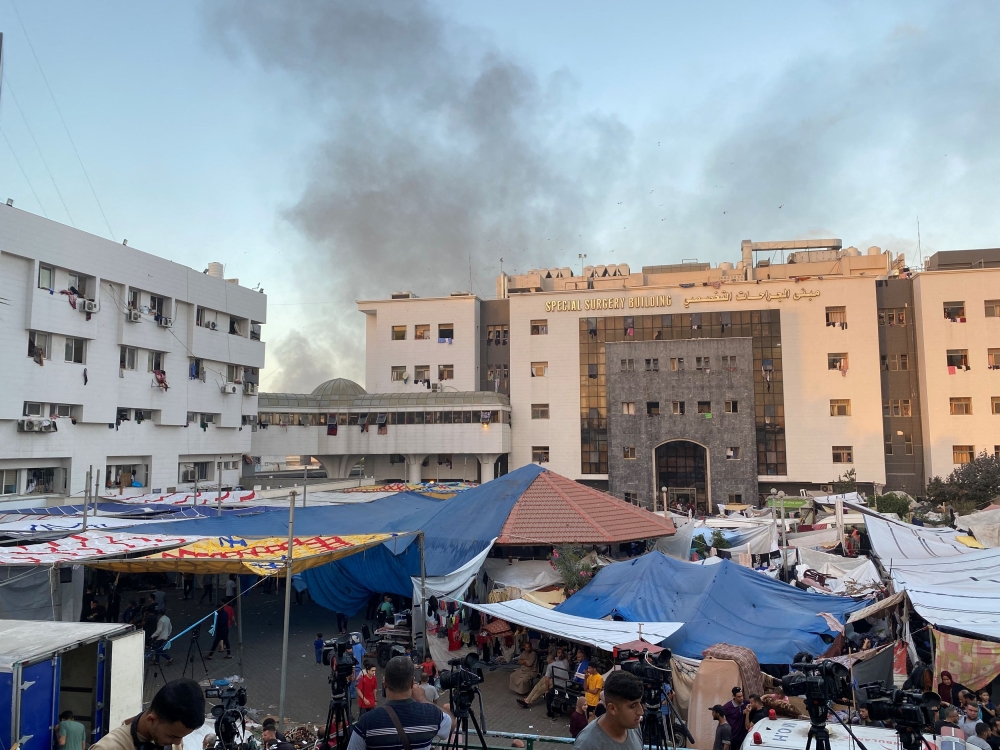 Smoke rises as displaced Palestinians take shelter at Al Shifa hospital, amid the ongoing conflict between Hamas and Israel, in Gaza City, November 8, 2023.  — Reuters pic