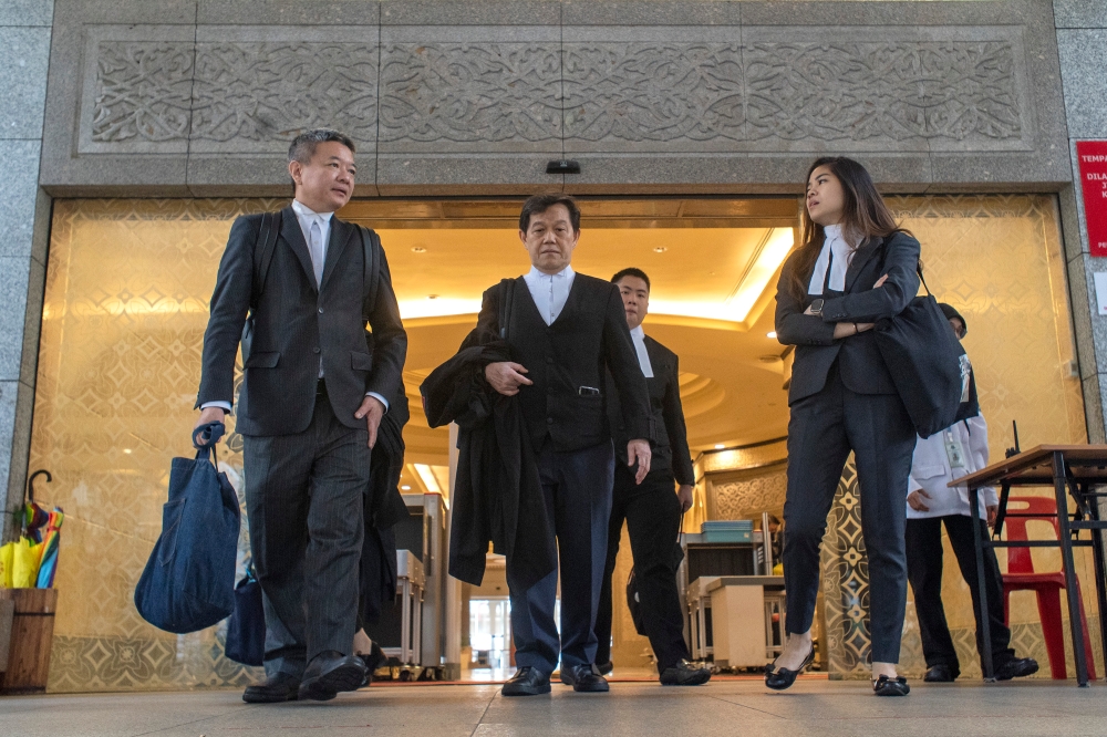 Lawyers Guok Ngek Seong (left) and Datuk Hisyam Teh Poh Teik (centre) are pictured at the Palace of Justice in Putrajaya November 14, 2023. — Picture by Shafwan Zaidon