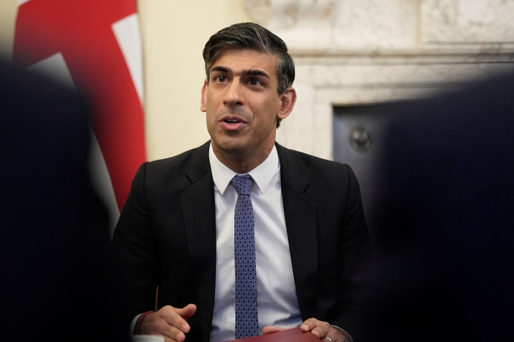 British Prime Minister Rishi Sunak hopes the Rwanda scheme will help stop the flow of migrants across the Channel from Europe in small boats, and so deliver one of his key policy pledges and energise his ailing premiership ahead of an election expected next year. — Pool via Reuters pic