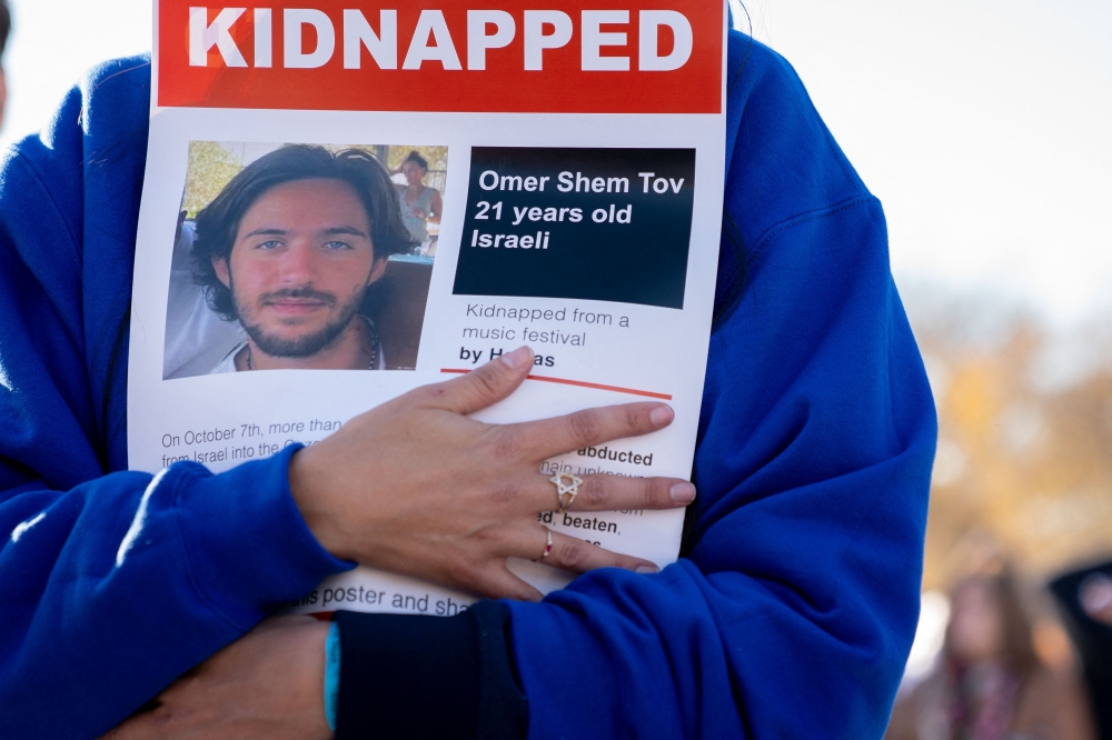 A demonstrator holds a poster showing 21-year-old Israeli Omer Shem Tov, who was kidnapped by Hamas militants on October 7, 2023, during a demonstration in support of Israel, to denounce antisemitism and call for the release of hostages on the National Mall in Washington, DC, on November 14, 2023. — AFP pic
