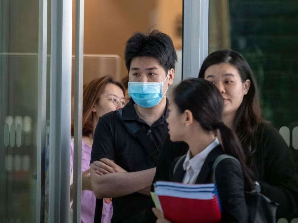 Ng Yong Kuan (wearing mask) at the State Courts in October 2023. — TODAY pic