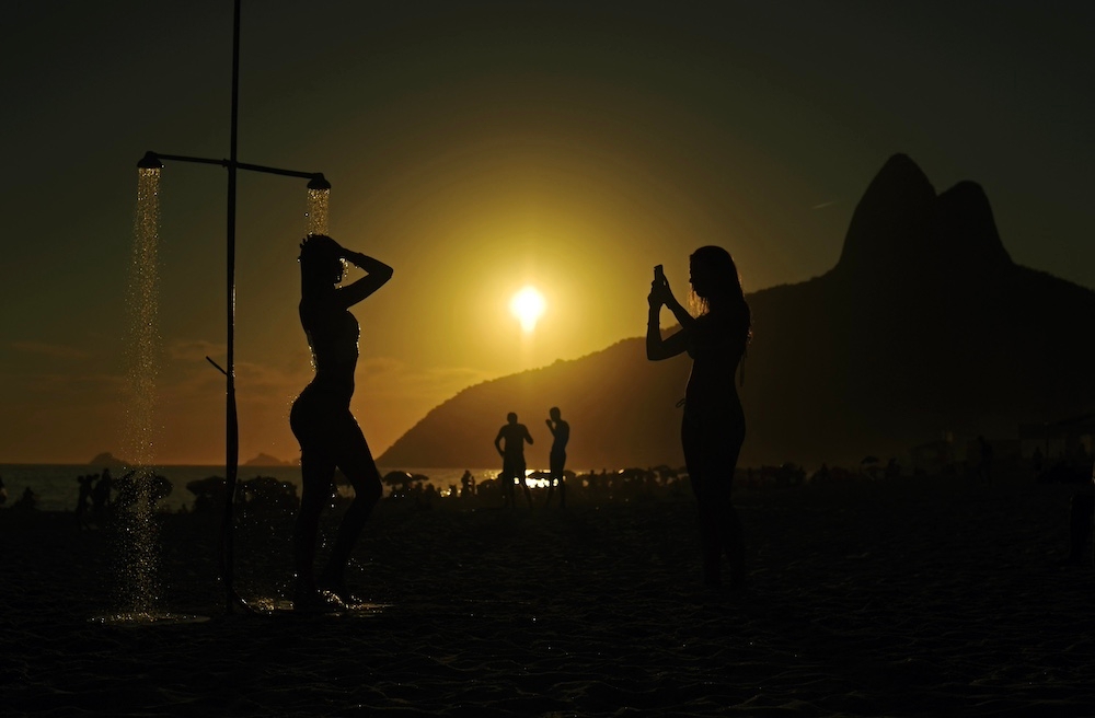 Beachgoers take photos at Ipanema beach at sunset in Rio de Janeiro, Brazil, on 8 January 2019. — AFP file pic