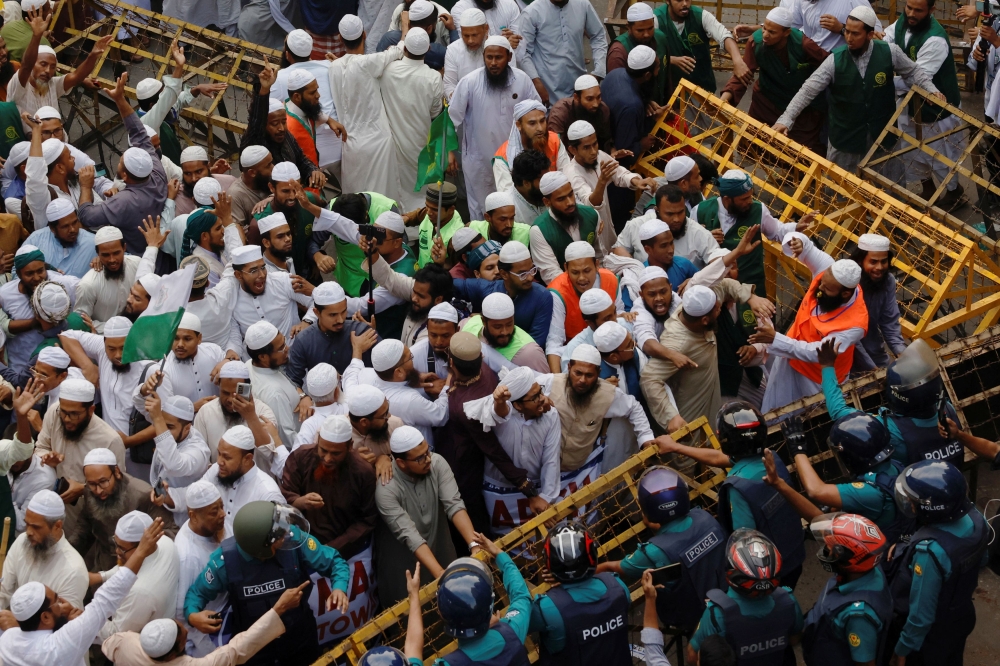 Members of the Islami Andolan Bangladesh, a political party, try to remove barricades as they join in a mass protest march towards the Election Commission, ahead of the election schedule declaration, in Dhaka, Bangladesh, November 15, 2023. — Reuters pic