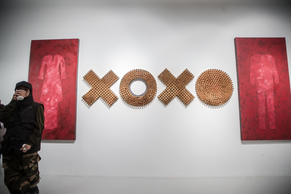 The 'Darah Syurga' portrait by Dzurfazree features a pair of baju Melayu and baju kebaya drenched in blood. — Picture by Raymond Manuel