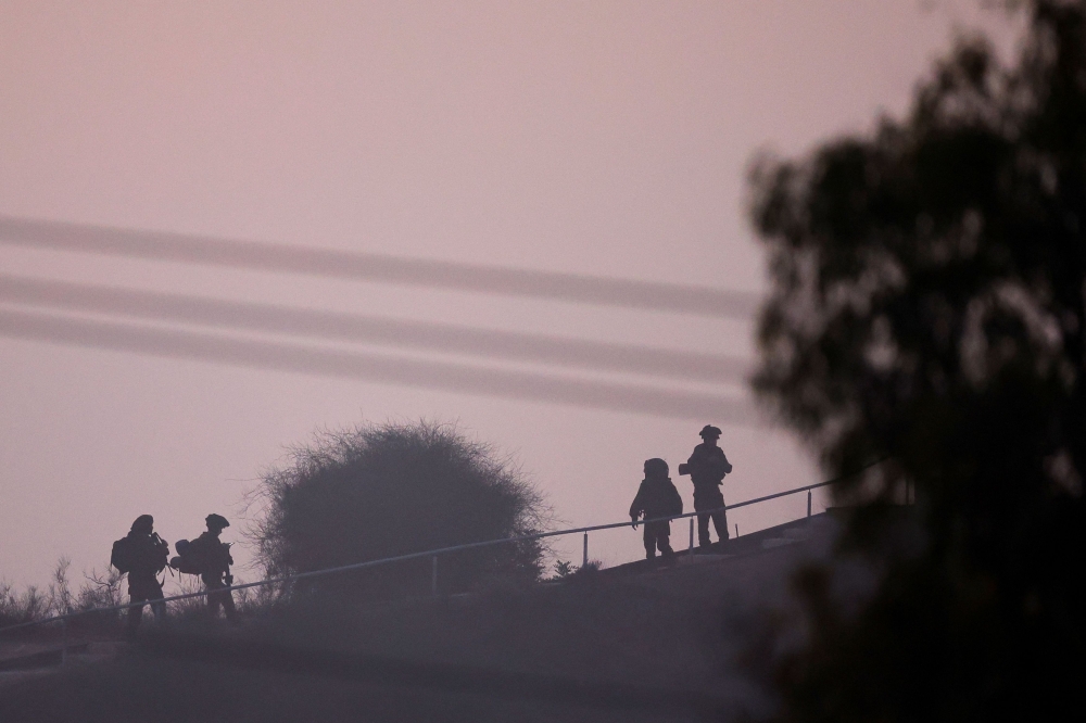 Soldiers of Israel's army move from the border with Gaza, as seen from Southern Israel, amid the ongoing conflict between Israel and the Palestinian group Hamas, November 16, 2023. — Reuters pic