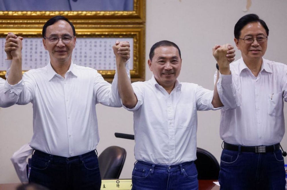 The Chairman of the Kuomintang (KMT), Taiwan's main opposition party, Eric Chu and Mayor of New Taipei Hou Yu-ih celebrate as Hou becomes the presidential candidate, in Taipei, Taiwan May 17, 2023. — Reuters pic