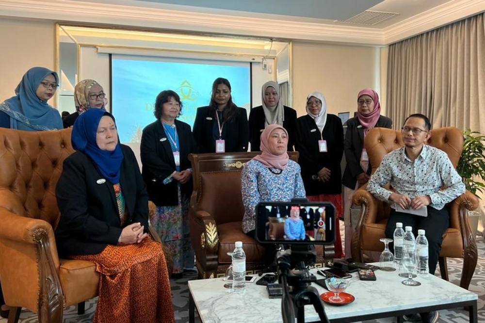 Nancy (seated centre) delivers some points during the press conference. — Borneo Post pic