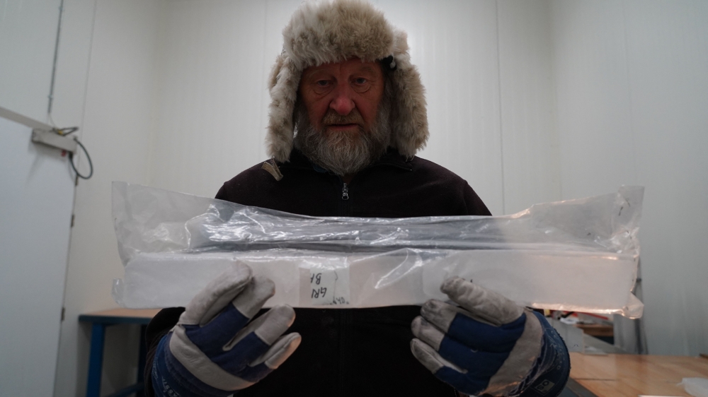 Joergen Peder Steffensen, professor of ice core related research at the Niels Bohr Institute, University of Copenhagen, holds part of an ice core sample in the University of Copenhagen's ice core repository in Copenhagen, Denmark, on October 26, 2023. — AFP pic