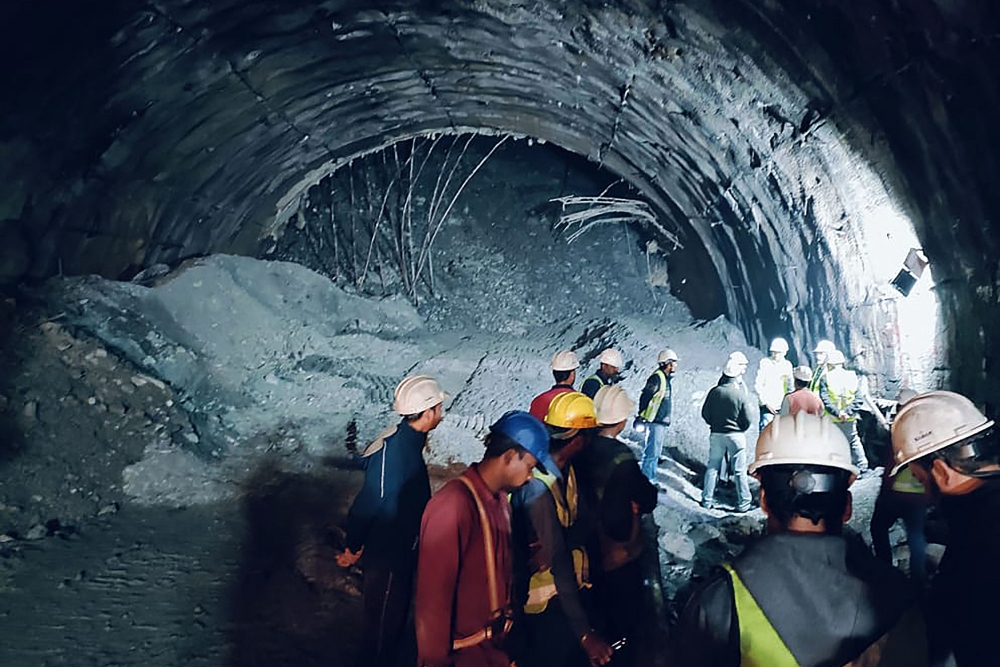 Indian rescuers are considering opening a vertical shaft to free 41 men trapped in a collapsed tunnel after drilling at the site was paused over fears of further cave-ins and as efforts stretched into a second week. — AFP pic
