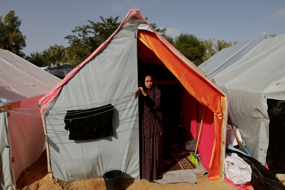 A woman looks out from a tent as displaced Palestinians, who fled their houses due to Israeli strikes, shelter in tents at Nasser Hospital, amid the ongoing conflict between Israel and the Palestinian Islamist group Hamas, in Khan Younis in the southern Gaza Strip November 19, 2023. — Reuters pic