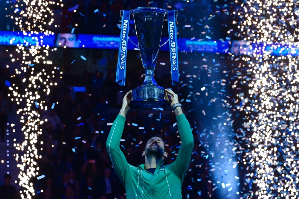 Serbia's Novak Djokovic lifts the trophy after winning the final match against Italy's Jannik Sinner at the ATP Finals tennis tournament in Turin November 19, 2023. — AFP pic