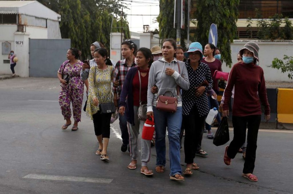 Garment workers leave for home after work at a factory, on the outskirts of Phnom Penh, Cambodia, October 16, 2018. — Reuters pic