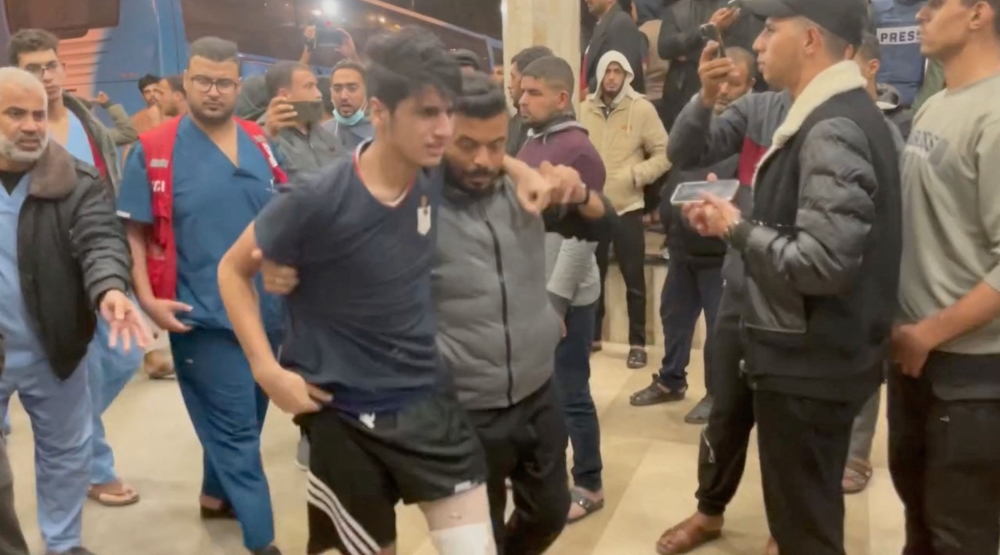 People assist injured Palestinians at Nasser Hospital in Khan Younis in the southern Gaza Strip in this screengrab from a handout video released on November 21, 2023. — Palestinian Ministry of Health handout via Reuters