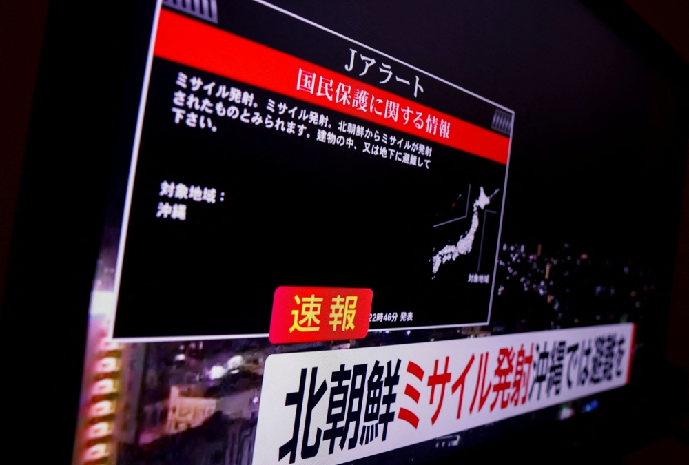 A TV screen displays a warning message called 'J-alert' after the Japanese government issued an emergency warning for residents of the southern prefecture of Okinawa, saying a missile had been launched from North Korea and that residents of Okinawa prefecture should take cover indoors, in Tokyo, Japan November 21, 2023. — Reuters pic