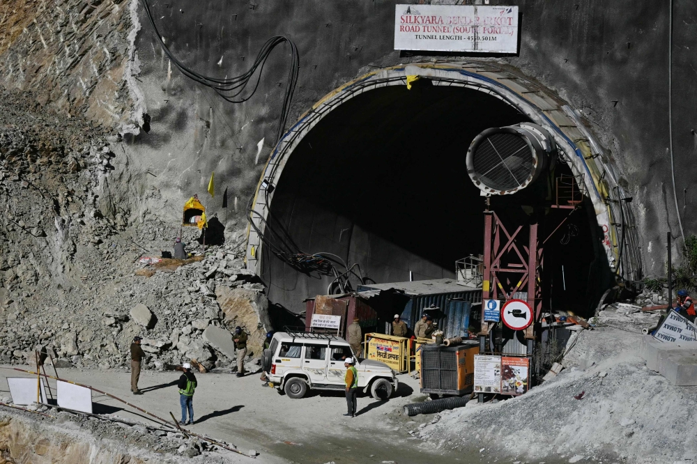 Indian rescue teams cleared rubble with excavators and dug tunnels today to clear a path for long metal tubes — the hoped-for escape route for dozens of workers trapped in a collapsed road tunnel for 11 days. — AFP pic