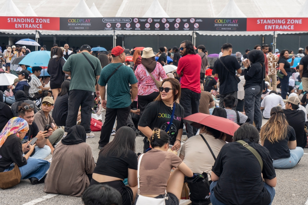 Concertgoers waiting in line at the Standing Zone (Cat3) line at Bukit Jalil National Stadium.  — Picture by Shafwan Zaidon. 