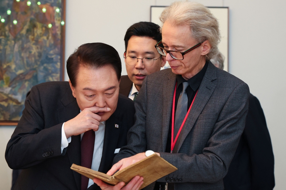 Head of Library at The Royal Society, Keith Moore, shows an artifact to South Korea’s President Yoon Suk Yeol at the Royal Society, in London, Britain November 22, 2023. — Reuters pic