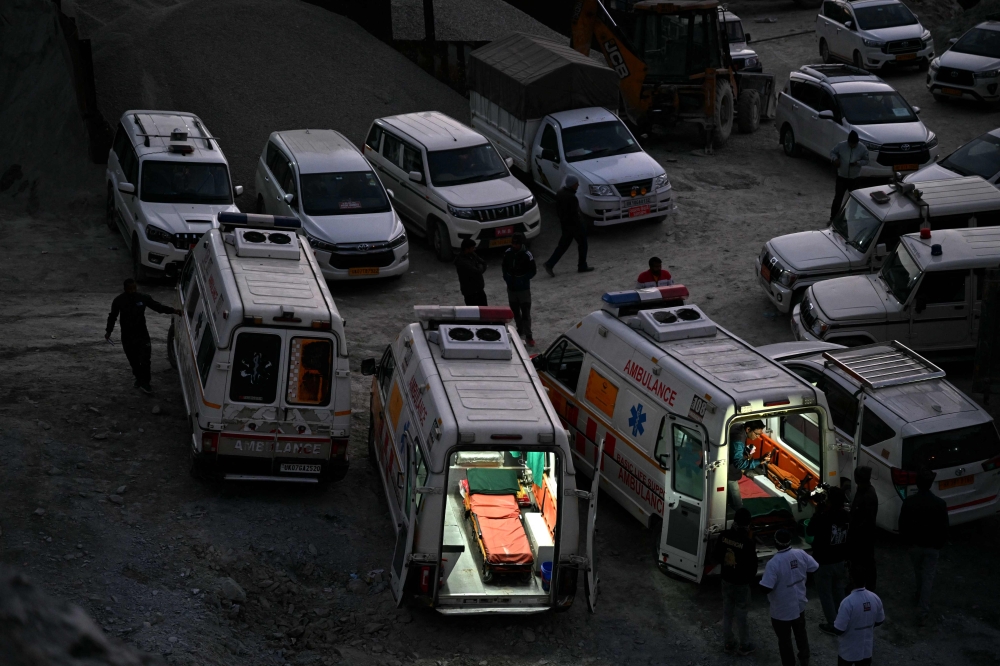 Ambulances were on standby this morning as Indian rescuers dug through the final metres of debris separating them from 41 workers trapped, for nearly two weeks, in a collapsed road tunnel. — AFP pic