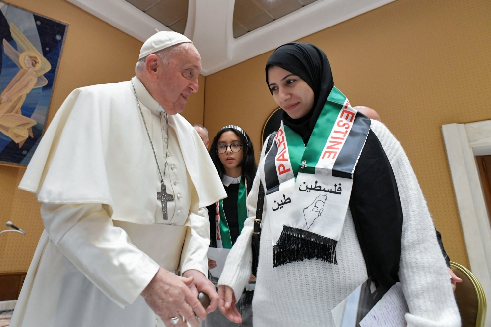 Pope Francis meets with Palestinians whose relatives are stranded in Gaza. — Reuters pic