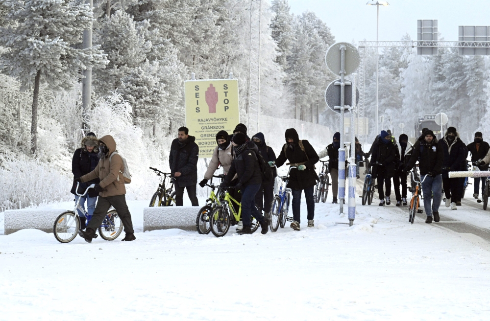 Migrants with bicycles at the international border crossing at Salla, Finnish Lapland on November 21, 2023. — AFP pic