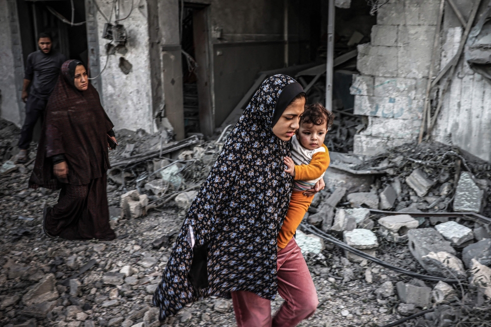 People fleeing following an Israeli strike in Rafah, southern Gaza Strip. — AFP pic