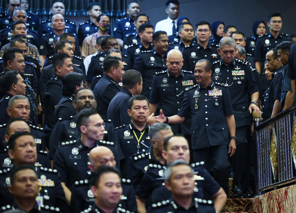 Inspector-General of Police Tan Sri Razarudin Husain shakes hands with officers and policemen present at a ceremony on rejecting corruption and launching of 3C Regulations in conjunction with the 2023 Integrity Month at the Royal Malaysia Police College in Cheras, November 23, 2023. — Bernama pic 
