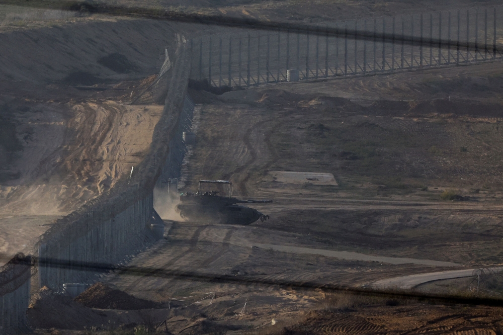 A tank maneuvers through a border fence at the Israel-Gaza border, amid the ongoing conflict between Israel and the Palestinian group Hamas, as seen from south Israel November 23, 2023. — Reuters pic