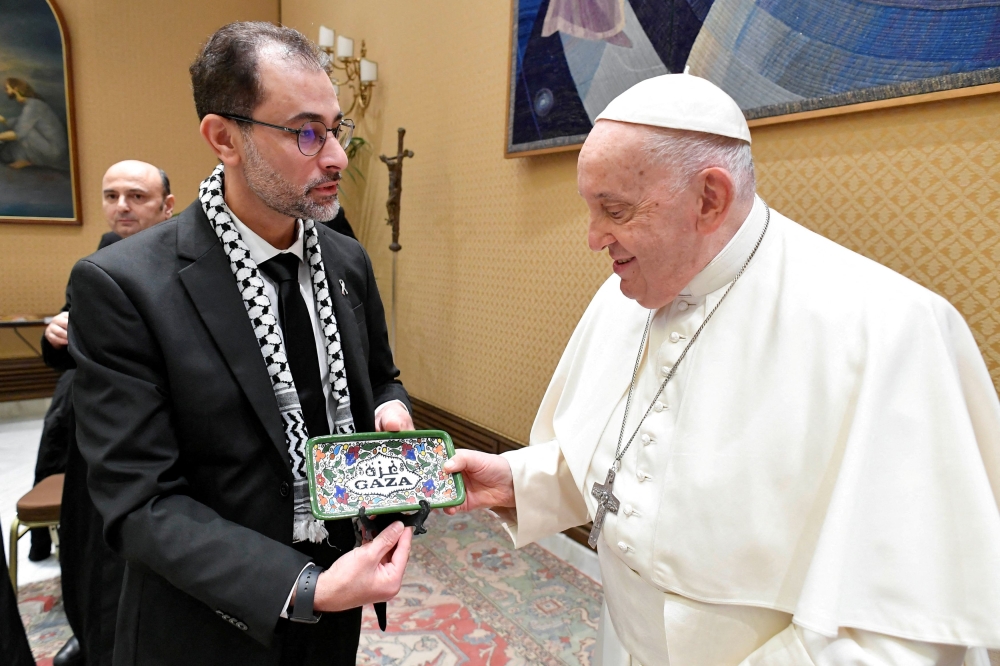 Pope Francis meets with Palestinians whose relatives are stranded in Gaza, amid conflict between Israel and the Palestinian Islamist group Hamas, at the Vatican November 22, 2023. — Reuters pic