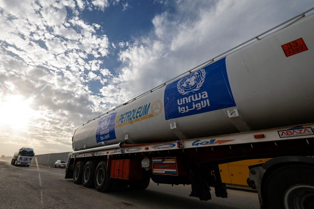 Trucks carrying humanitarian aid from the United Nations Relief and Works Agency for Palestine Refugees (UNRWA) arrive at the Egyptian side of the Rafah border crossing with the Gaza Strip on November 22, 2023, amid ongoing battles between Israel and the Palestinian militant group Hamas. — AFP pic