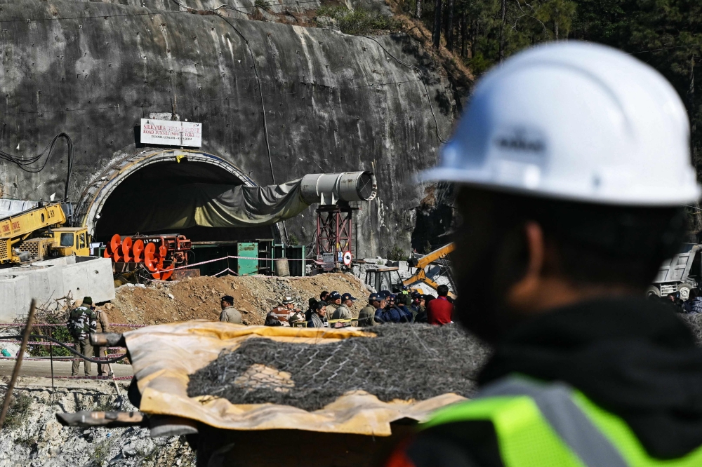 A rescue personnel stands near an entrance of the Silkyara under construction road tunnel, during the final phase of a rescue operation, days after a portion of it collapsed in the Uttarkashi district of India's Uttarakhand state on November 23, 2023. — AFP pic