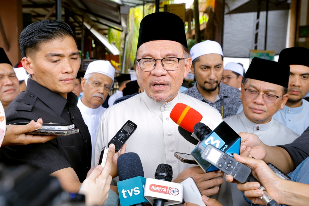 Prime Minister Datuk Seri Anwar Ibrahim speaks to reporters after performing Friday prayers at Surau Al-Furqan in Putrajaya, November 24, 2023. — Bernama pic 