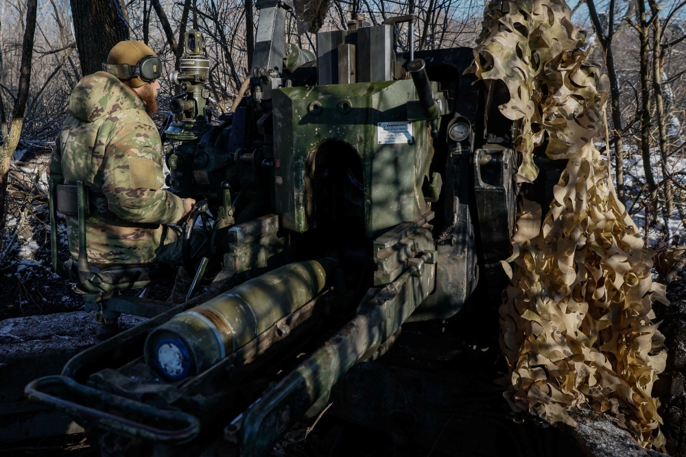 A serviceman of the 12th Special Forces Brigade Azov of the National Guard of Ukraine prepares to fire from a howitzer LH-70 towards Russian troops at a position near a frontline, amid Russia's attack on Ukraine, at an undisclosed location in Donetsk region, Ukraine, November 22, 2023. — Reuters pic