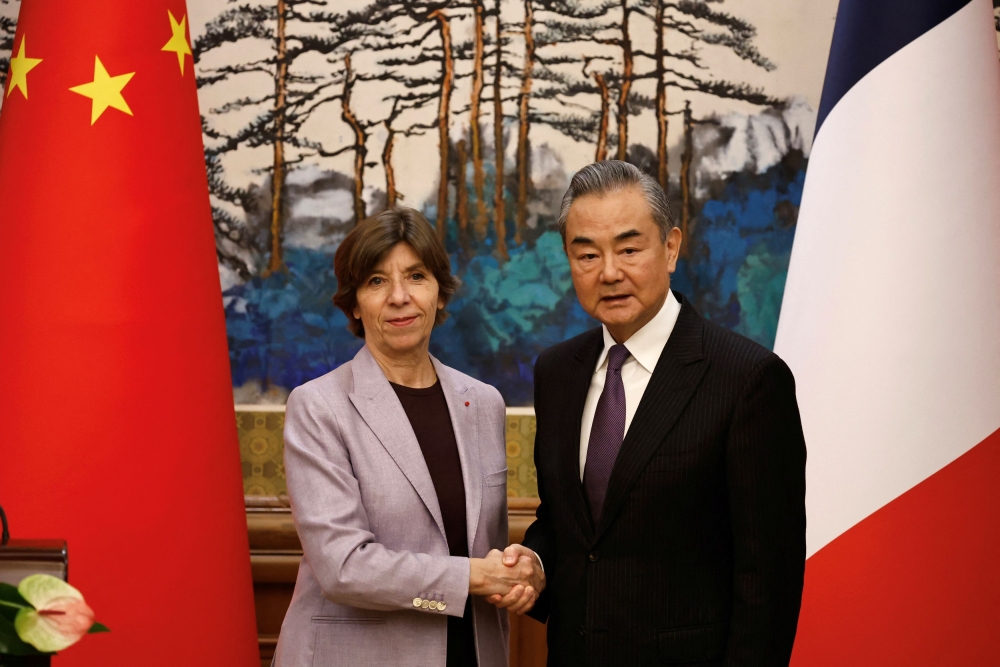 French Foreign Minister Catherine Colonna and Chinese Foreign Minister Wang Yi shake hands following a press conference at the Diaoyutai State Guesthouse in Beijing November 24, 2023. — Reuters pic