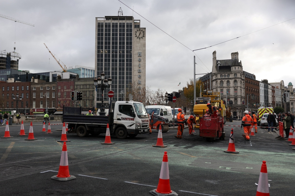 Workers repair a damaged road in the aftermath of a school stabbing that left several children and adults injured, which led to a riot, in Dublin November 24, 2023. — Reuters pic