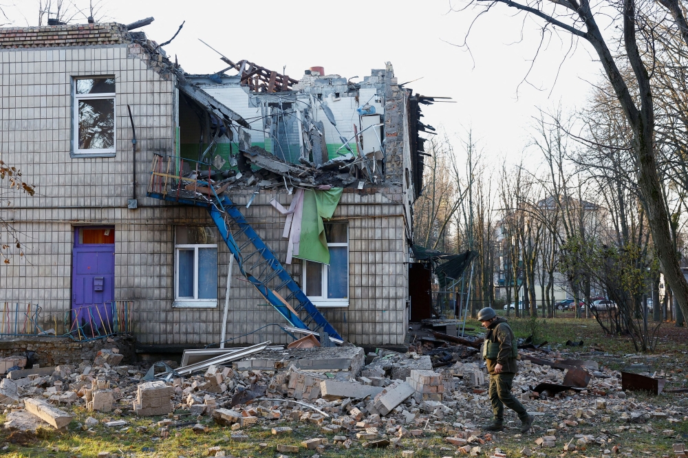 Police officers inspect the compound of a kindergarten damaged during Russian drone strikes, amid Russia’s attack on Ukraine, in Kyiv, Ukraine November 25, 2023. ― Reuters pic